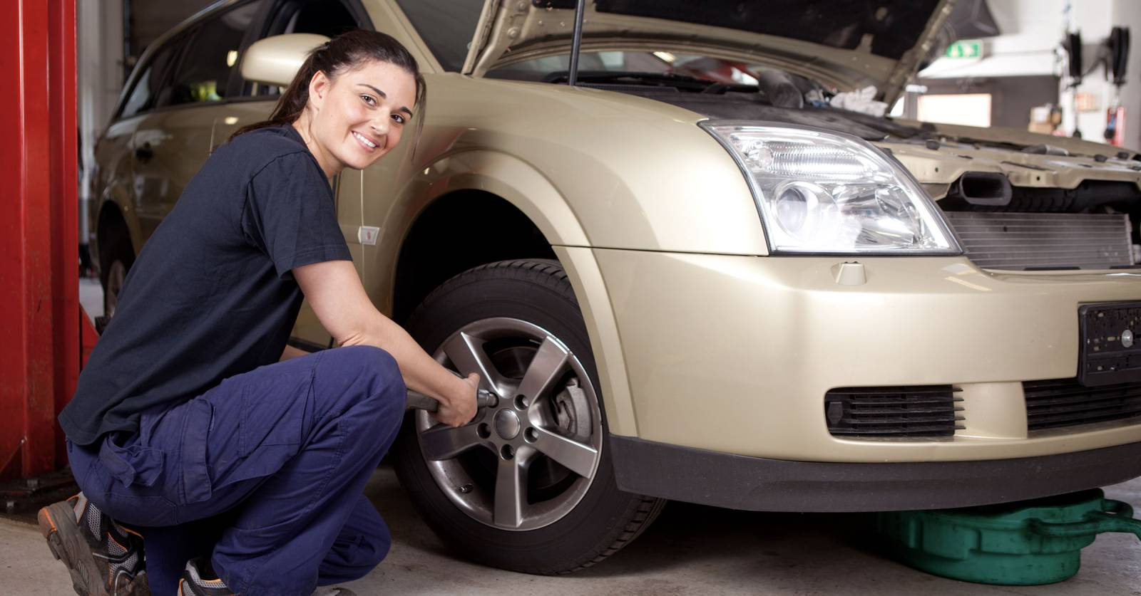 A mechanic working on a car, symbolizing reliable service.